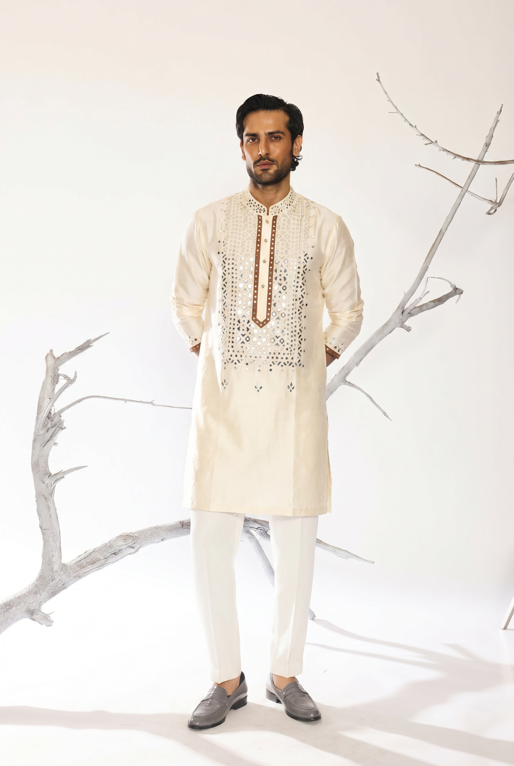 Safed-Gul ivory kurta detail view - hand embroidered mirror and leather patch work by AVK atelier New Delhi